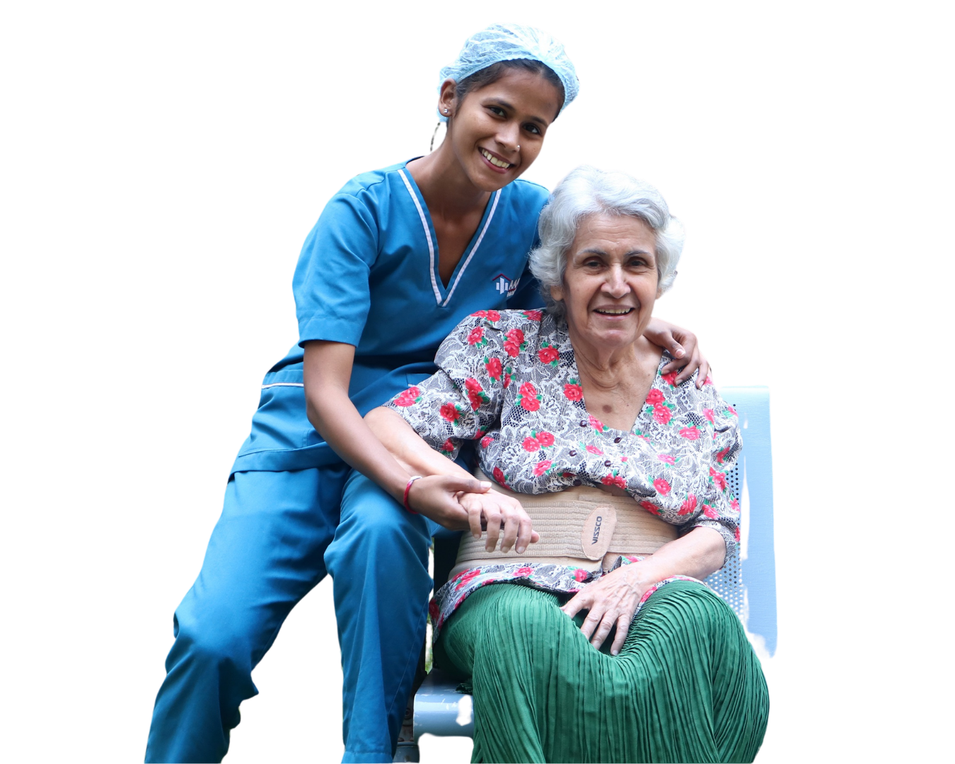 Smiling caregiver in blue scrubs with an elderly woman
